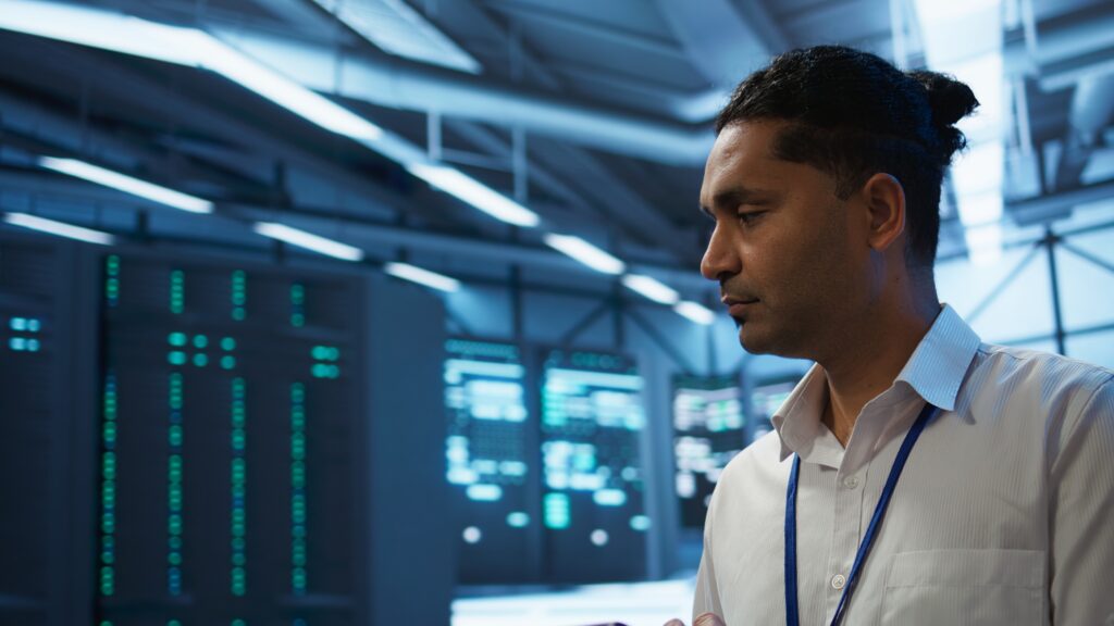 IT professional managing cloud and server systems in a server room