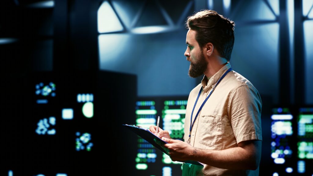 Cloud engineer reviewing infrastructure in a data centre