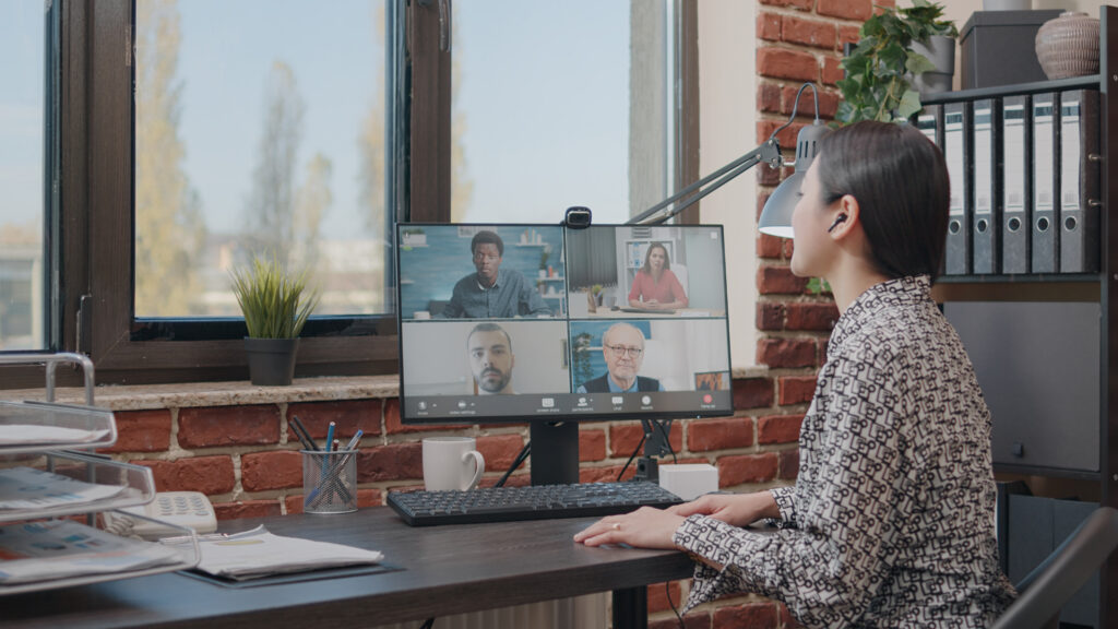 Employee collaborating with a hybrid team over a cloud video call