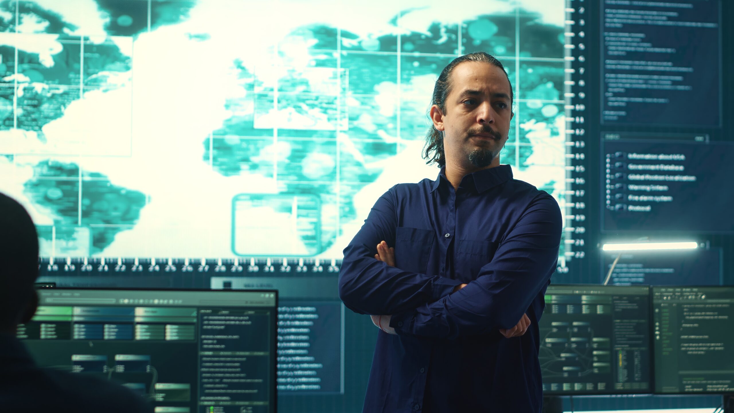 Cyber security analyst in a security operations centre monitoring global threats
