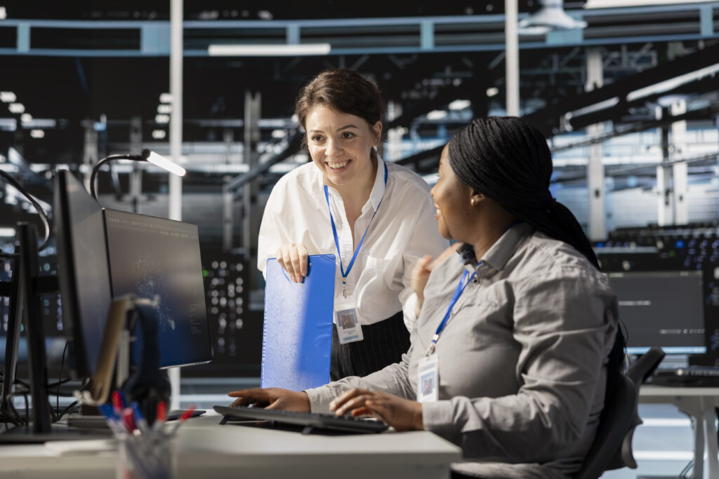IT team members smiling after resolving a technology issue