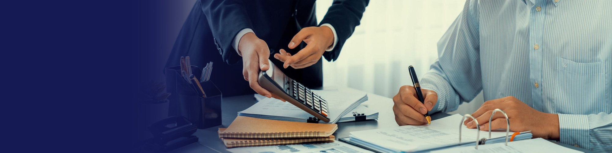 Accountants reviewing financial documents with a calculator