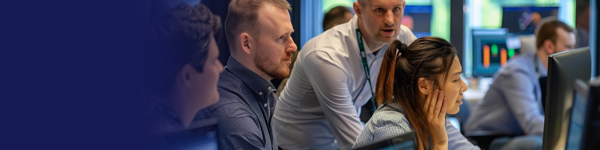 IT engineers collaborating with an in-house IT team at computer workstations