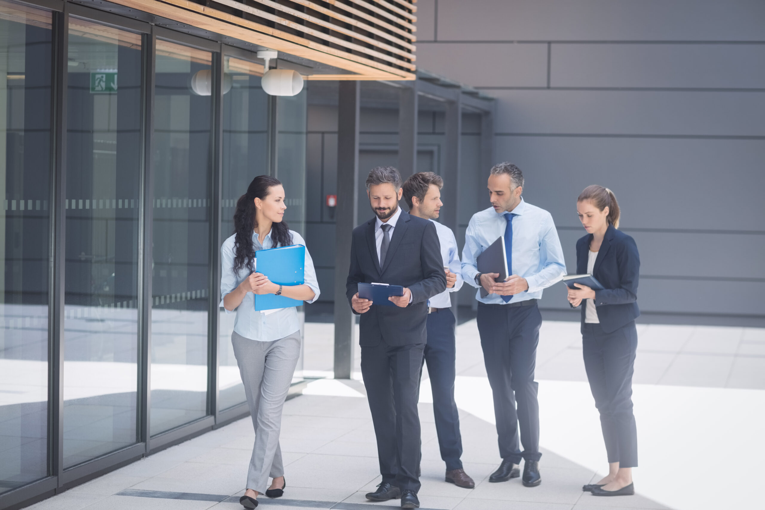 Business team walking outside a modern office building in Pickering