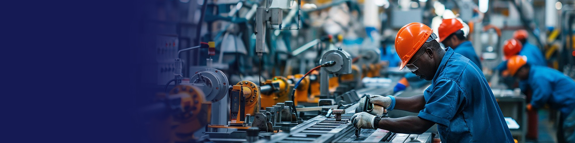 Factory workers in hard hats operating machinery on a production line