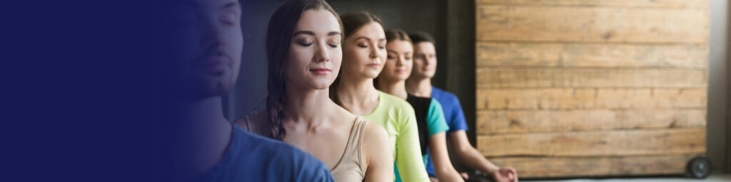 Group of people meditating in a wellness studio