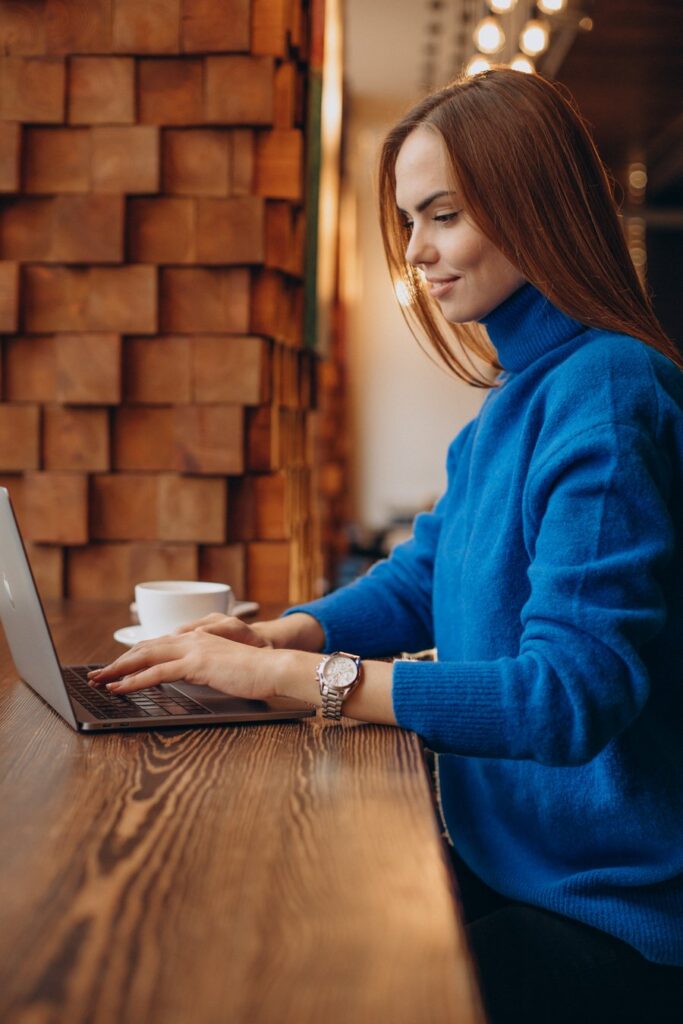 Business owner working on a laptop in a cafe